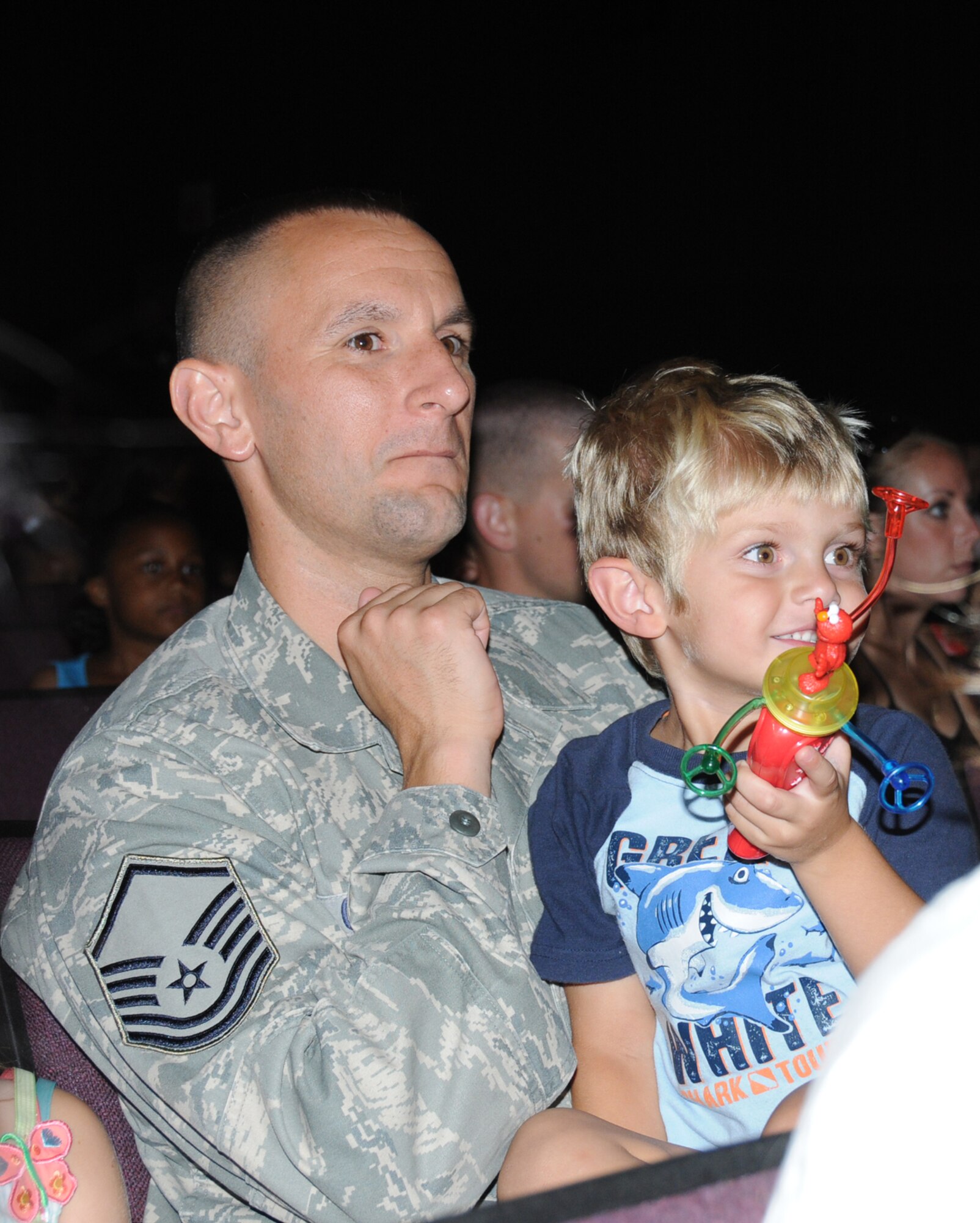 Master Sgt. Adam Chuilli, 2nd Air Force, and his 4-year-old son, Owen, enjoy one of the June 24 programs at Welch Auditorium.  (U.S. Air Force photo by Kemberly Groue)