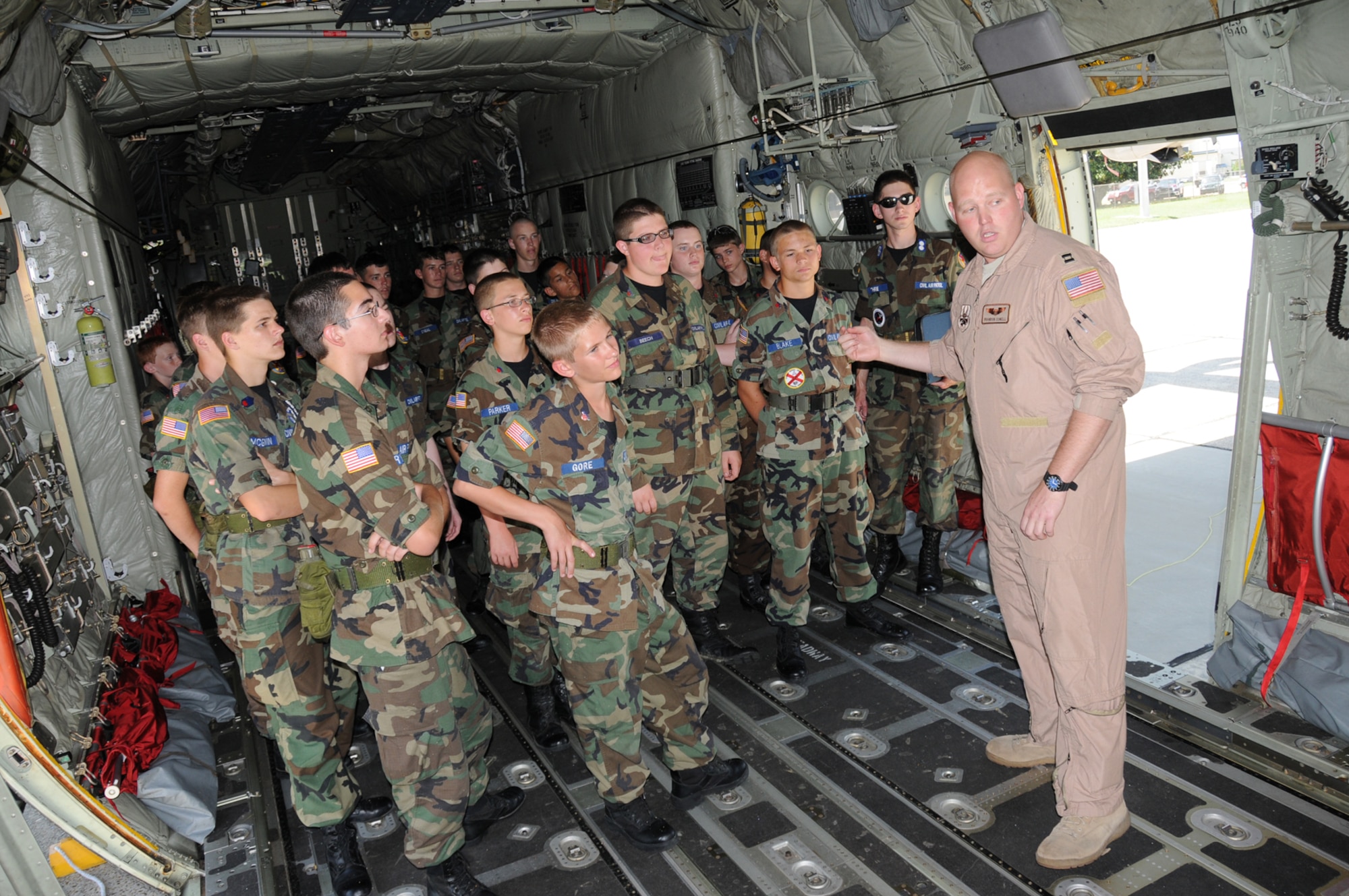 Capt. Brandon Cowell, right, 815th Airlift Squadron, gives a tour of a C-130J model aircraft to a group of Mississippi Civil Air Patrol cadets June 23.  Brig. Gen. Ian Dickinson, 81st Training Wing commander, welcomed the group of more than 130 cadets during their annual tour of Keesler.  General Dickinson reflected on his experience and involvement in the Civil Air Patrol and encouraged the cadets to take the CAP challenge as an great opportunity to excel.  The cadets also toured the 81st Medical Group Hospital, the air traffic control school and the fire station.  (U.S. Air Force photo by Kemberly Groue)