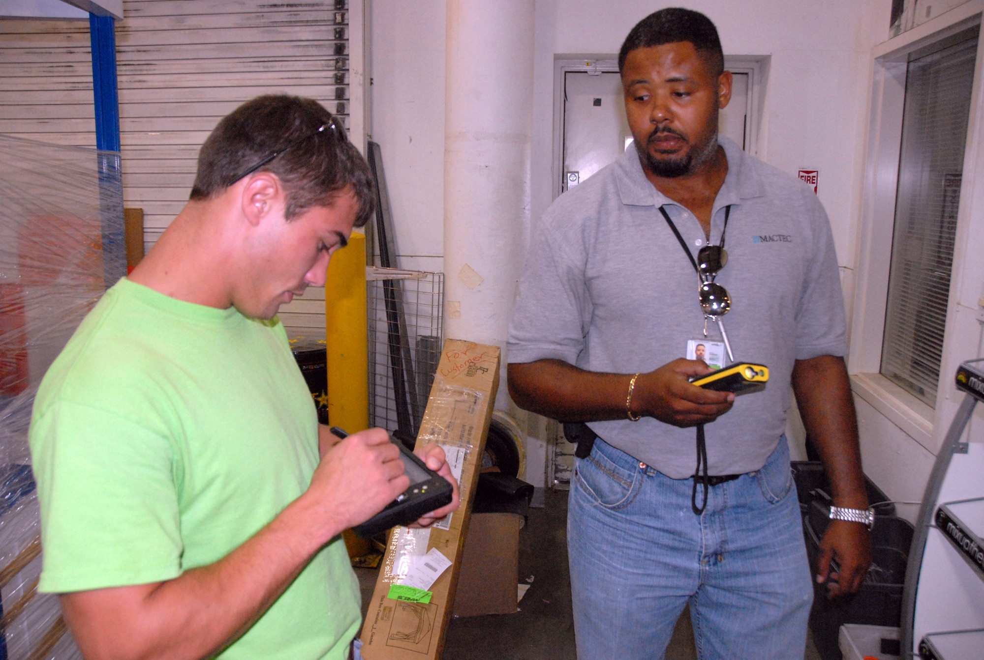 Engineering technicians Dillon Daniels and Ikea Battle take measurements at the Base Exchange as part of data collection for a space optimization study. U. S. Air Force photo by Wayne Crenshaw