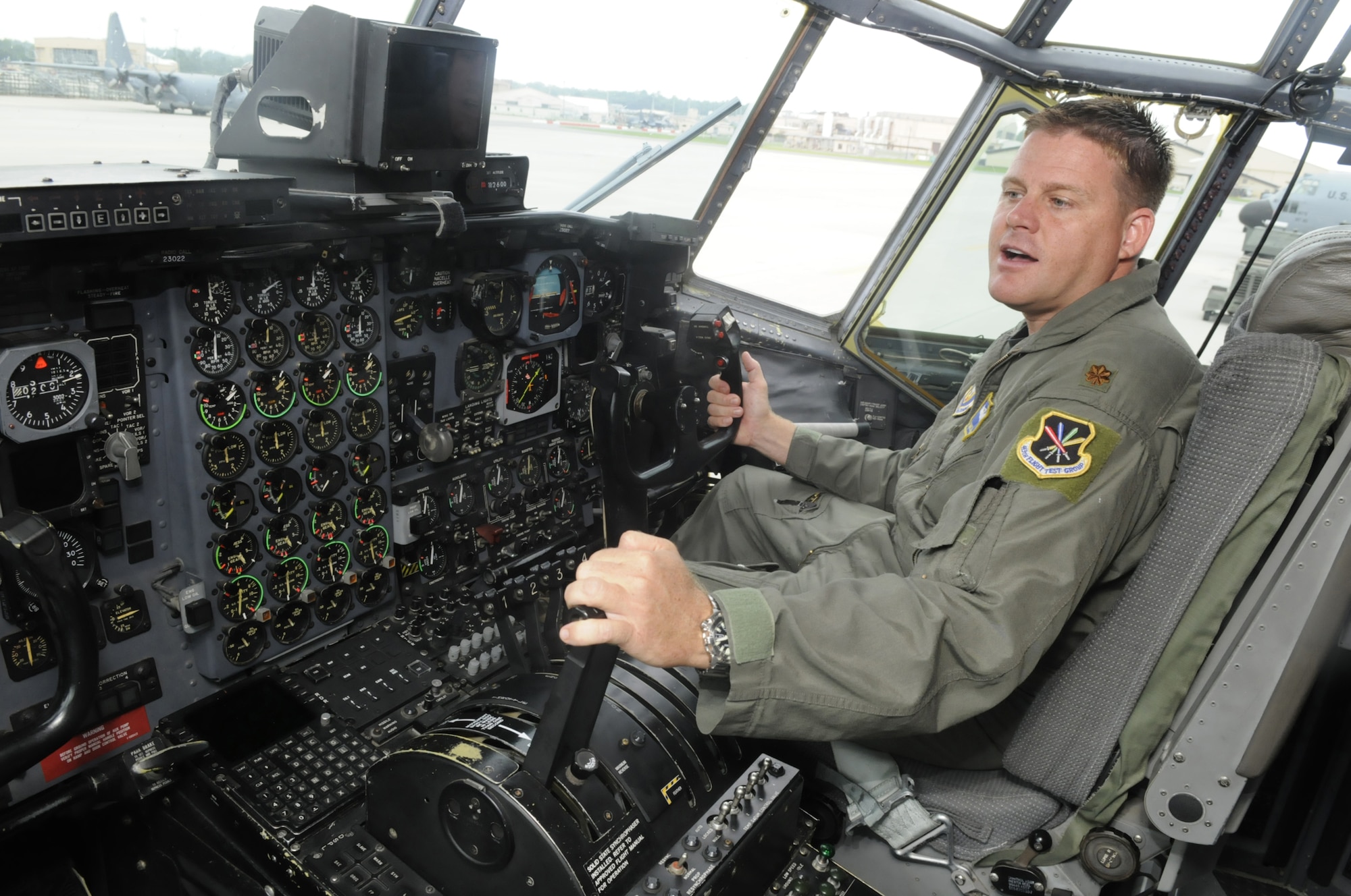 Maj. Jeremy Mickelson, C-130 pilot, talks from inside the cockpit of a C-130. The C-130 Avionics Modernization Program will replace the cockpit's current display with digital gauges.  U. S. Air Force file photo by Sue Sapp