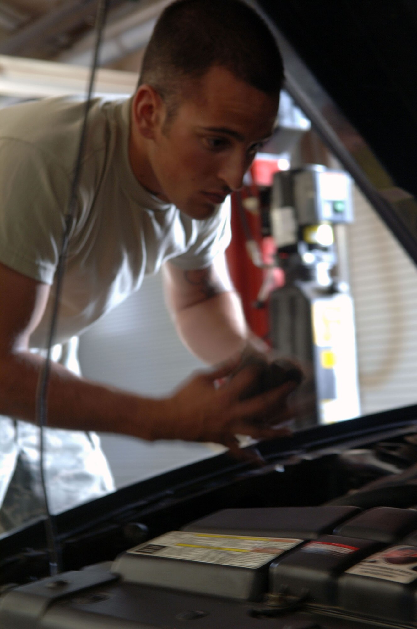 HOLLOMAN AIR FORCE BASE, N.M. -- Airman 1st Class Chad Donovan, 849th Aircraft Maintenance Squadron, works on his vehicle at the Auto Hobby Shop, June 29, 2010. Airman Donovan is a frequent visitor and utilizes the equipment often since his arrival at Holloman. (U.S. Air Force photo by Airman 1st Class Siuta Ika / Released)