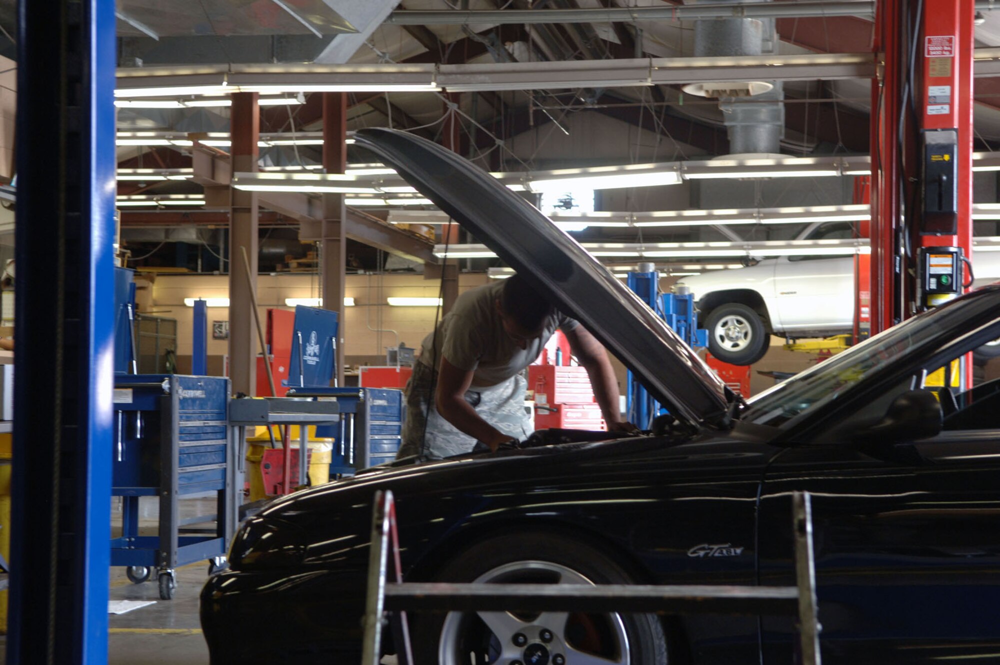 HOLLOMAN AIR FORCE BASE, N.M. -- Airman 1st Class Chad Donovan, 849th Aircraft Maintenance Squadron, works on his vehicle at the Auto Hobby Shop, June 29, 2010. The Auto Hobby Shop provides tools and equipment to Holloman members and allows them to bring their vehicles in to work on them for an hourly charge. (U.S. Air Force photo by Airman 1st Class Siuta Ika / Released)