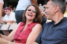 Col. and Mrs. Ogden share a laugh during the Charlotte Knights baseball game. The event was part of the Yellow Ribbon Reintegration program in late June. (USAF photo by SSgt. Terrica Jones, 916ARW/PA)