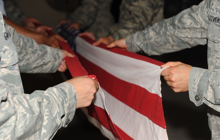 SEYMOUR JOHNSON AIR FORCE BASE, N.C. -- Honor Guard Airmen fold a flag during training here June 29, 2010. Prior to performing during official Honor Guard ceremonies, all new Airmen must complete two weeks of training to learn the drills. (U.S. Air Force photo/Senior Airman Gino Reyes)