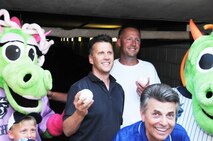Col. Randy Ogden, 916th ARW commander (center) poses with Homer the Dragon and some other Charlotte Knights fans in late June. (USAF photo by SSgt. Terrica Jones, 916ARW/PA)