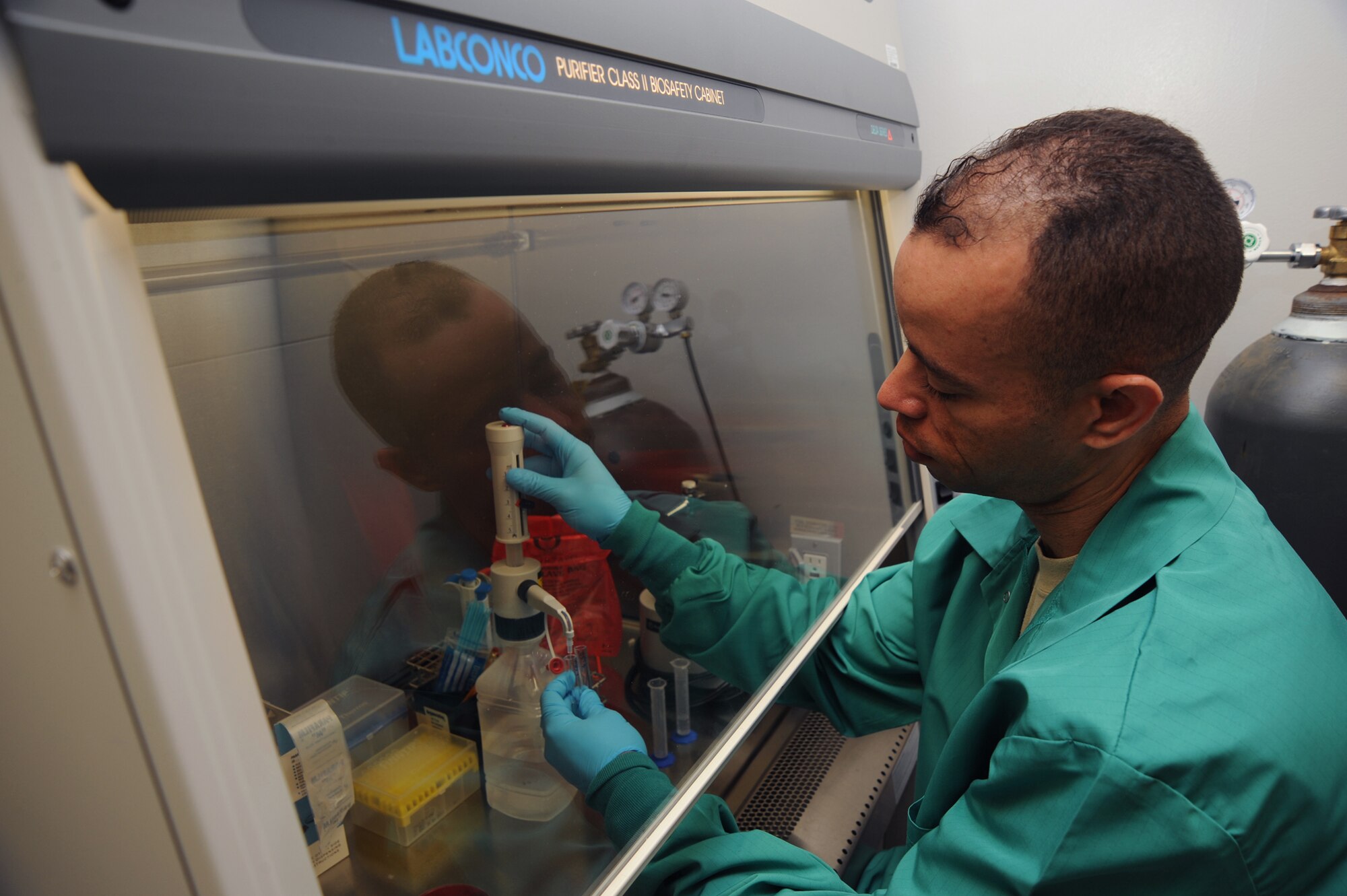 WHITEMAN AIR FORCE BASE, Mo., -- Tech. Sgt. Tirso Arjona, 509th Medical Squadron microbiology technician, sets up a urine culture for tracking infection.(U.S. Air Force photo/Staff Sgt. Jason Huddleston)