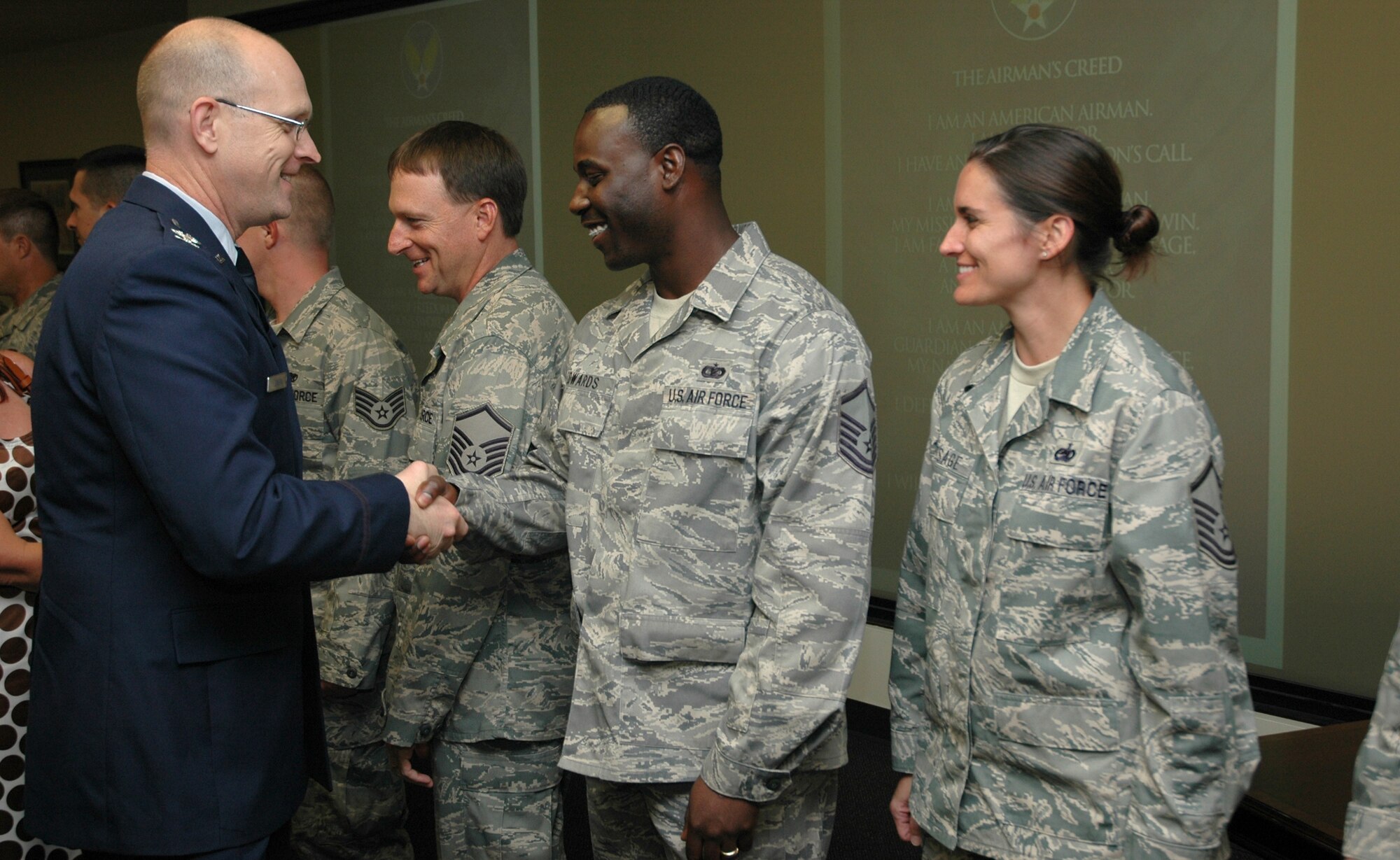 Col. Jay D. Jensen, Air Force Reserve Command chief of the programs division, congratulating Charleston’s newest NCO and Senior NCO inductees at a special ceremony June 26 at Charleston Air Force Base, S.C. (U.S. Air Force photo by Staff Sgt. Shane Ellis)