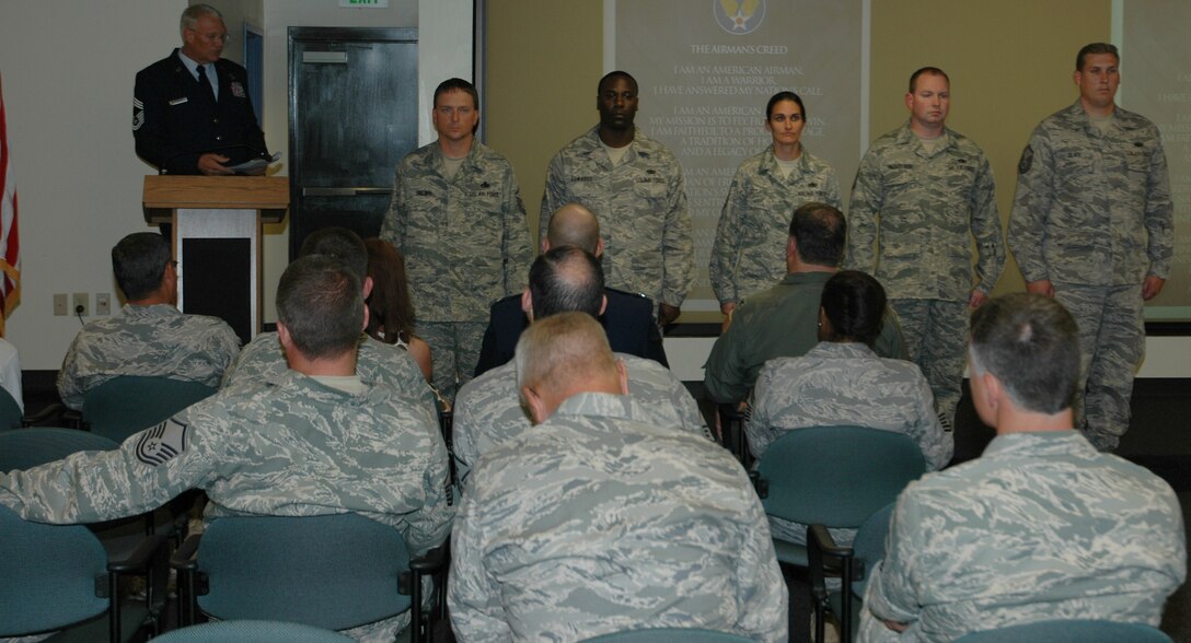 Chief Master Sgt. Michael Spanos, 701st Airlift Squadron loadmaster, administers the senior noncommissioned officer charge to Charleston’s newly promoted master sergeants during a special ceremony June 26. (U.S. Air Force photo by Staff Sgt. Shane Ellis)