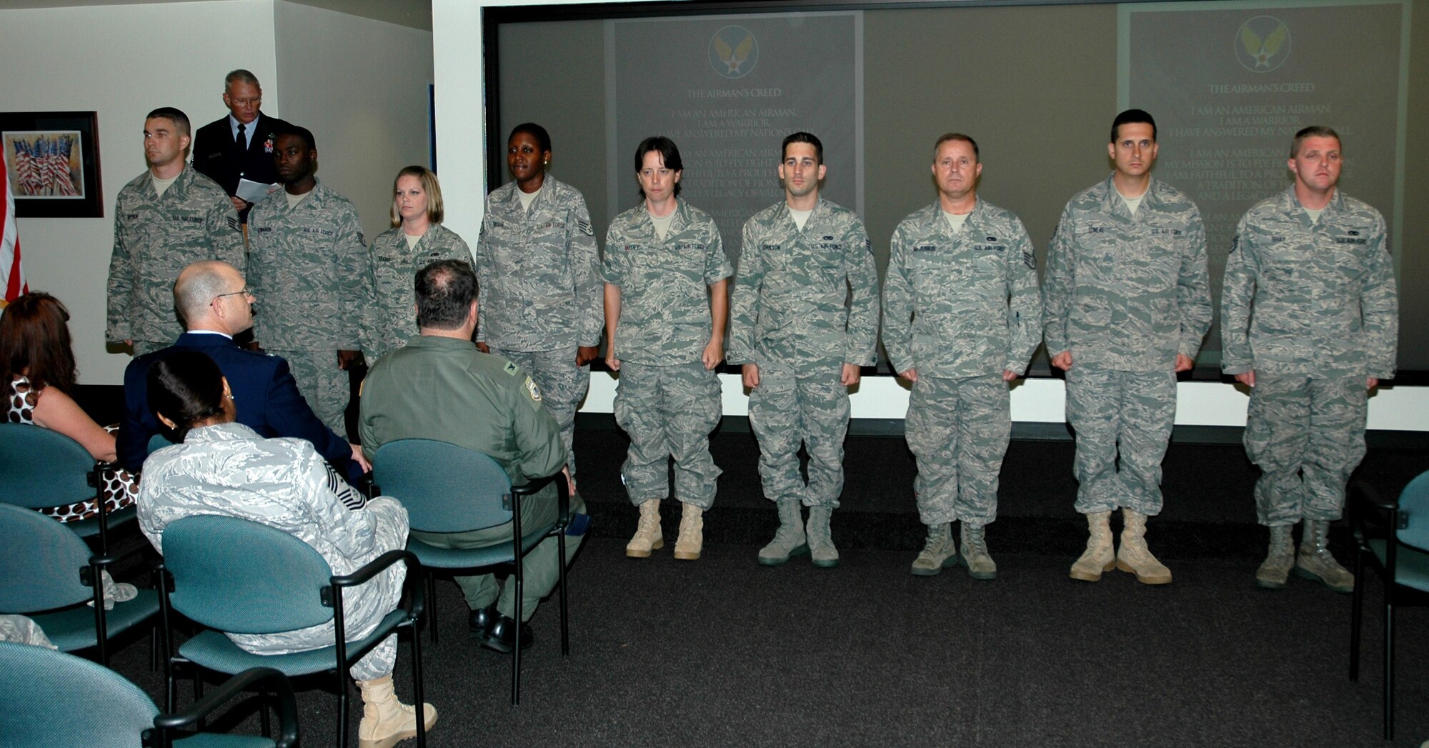 Chief Master Sgt. Michael Spanos, 701st Airlift Squadron loadmaster, administers the noncommissioned officer charge to Charleston’s newly promoted staff sergeants during a special ceremony June 26. (U.S. Air Force photo by Staff Sgt. Shane Ellis)