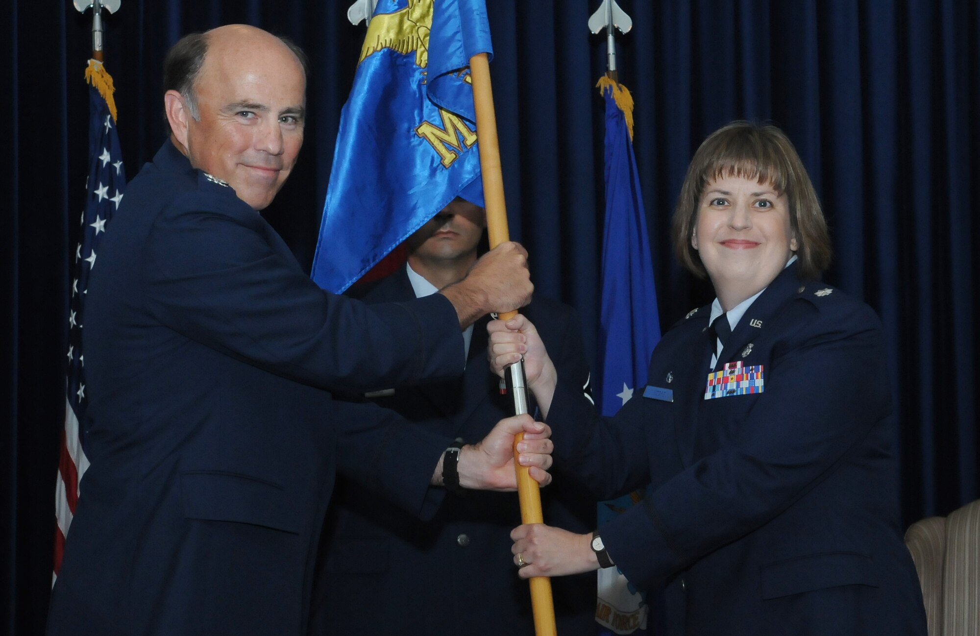 Lt. Col. Lisa A. Moore (right), accepts command of the 39th Medical Support Squadron from Col. Michael Johnson, 39th Medical Group commander, during the change of command ceremony Tuesday, June 30, 2010 at Incirlik Air Base Incirlik, Turkey. Prior to taking command of the 39th MDSS, Colonel Moore served as the Chief, Medical Readiness Plans and Programs Branch, Office of the Command Surgeon, Headquarters, Air Mobility Command, Scott Air Force Base, Ill. She was responsible for AMC directed contingency, disaster and exercise plans and support for expeditionary operations. The change of command ceremony is an Air Force tradition that gives unit Airmen the opportunity to see their new leader take command. (U.S. Air Force photo/Senior Airman Alexandre Montes)