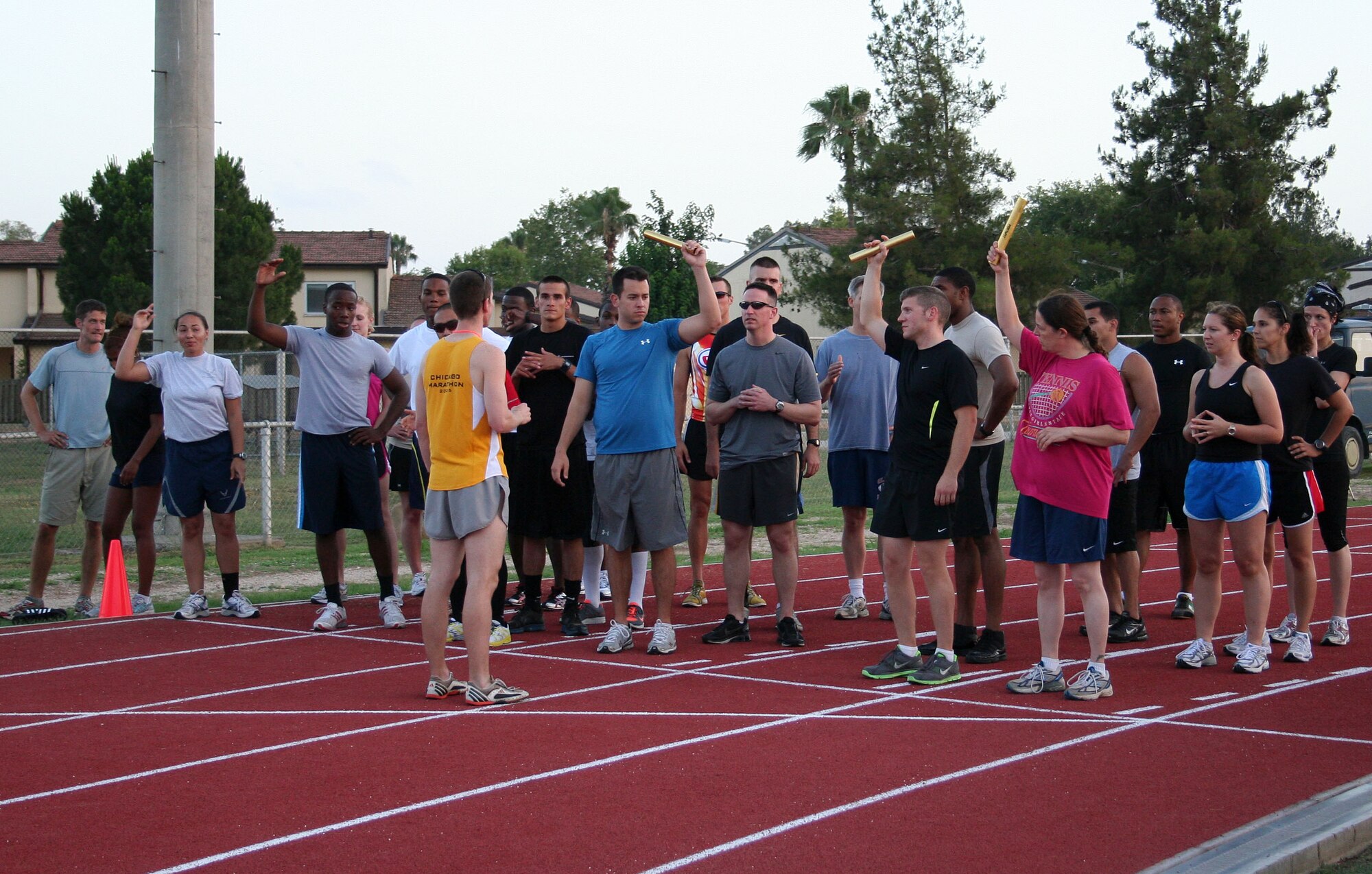 Seth Jenny, 39th Medical Operations Squadron, explains the 4x100-meter relay to participants of the Under the Lights Track Meet Wednesday, June 23, 2010 at Incirlik Air Base, Turkey.  The meet is an event held to allow participants to show off their running skills in a friendly competition.  (U.S. Air Force photo/Tech. Sgt. Steven Williams)
