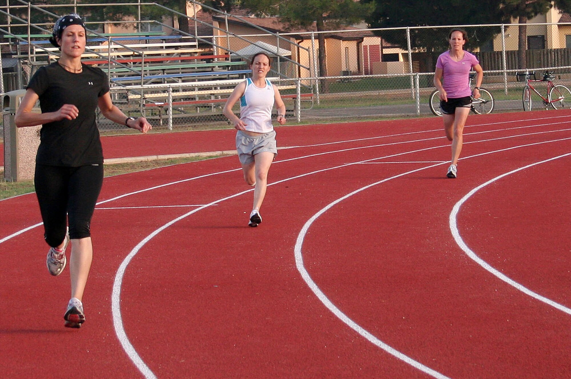 Jennifer Plante, 39th Operations Squadron, Capt. Angela Jenny and Capt. Elissa Ballas, 39th Medical Group, compete in the Women’s 400-meter race during the Under the Lights Track Meet Wednesday, June 23, 2010 at Incirlik Air Base, Turkey.  Capt. Ballas, (right) won the Women’s 400-meter race with a run time of 1 minute, 13.6 seconds.  (U.S. Air Force photo/Tech. Sgt. Steven Williams)