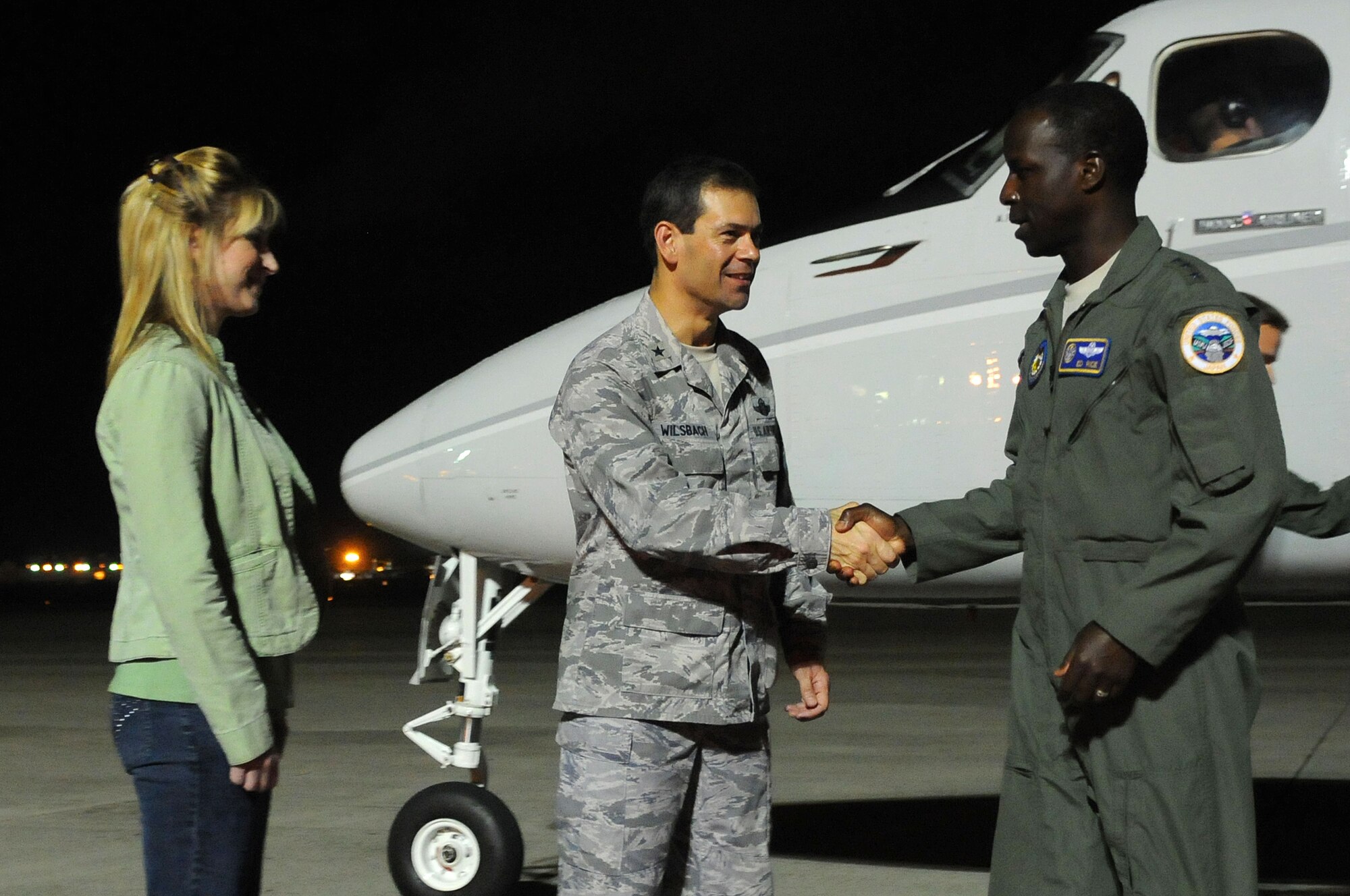 Lt. Gen. Edward Rice Jr., U.S. Forces Japan and 5th Air Force commander, is greeted by 18th Wing Commander Brig. Gen. and Cindy Wilsbach June 29. (U.S. Air Force photo / Staff Sgt. Christopher Hummel)