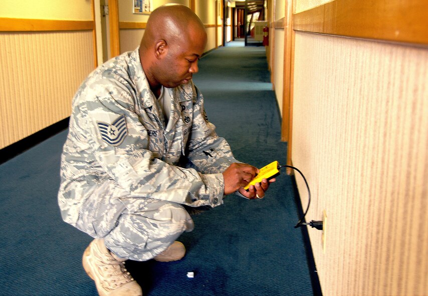 ANDERSEN AIR FORCE BASE, Guam - Staff Sgt. Carlos Rogers, 36th Wing ground safety manager, performs a safety check on an electrical outlet at the 36th Wing Headquarters building June 28.(U.S. Air Force photo by Airman Whitney Amstutz)