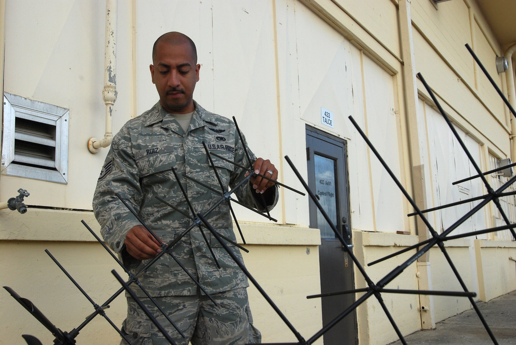 Staff Sgt. Jose Ruiz, 433rd Airlift Control Flight, Lackland Air Force Base, Texas, with some of the equipment the ALCF uses in their mission. 
<br>
<br>
433rd Airlift Control Flight can be compared to the multi-tool in your pocket, it's small but has many different functions and is a life saver in a jam.
<br>
<br>
"When there is an airfield that doesn't have any command post or any control on the field -- bare base -- we can go out there," Sergeant Ruiz said.
<br>
<br>
He said the 433rd ALCF can be self-sufficient for 30 days while being able to provide relief or emergency aid to an area.  In addition they can start and build a base where there was nothing before. 
<br>
<br>
The 433rd ALCF is made up of Air Reserve Technicians and traditional Reservists. A small unit of fewer than 20 members, it has about eight different Air Force Specialty Codes, including pilots, a loadmaster, a network communications specialist and a navigator.
<br>
<br>
"We do multiple exercises throughout the year for different contingencies or even just local exercises," Sergeant Ruiz said.  (U.S. Air Force photo/Airman 1st Class Brian McGloin)
