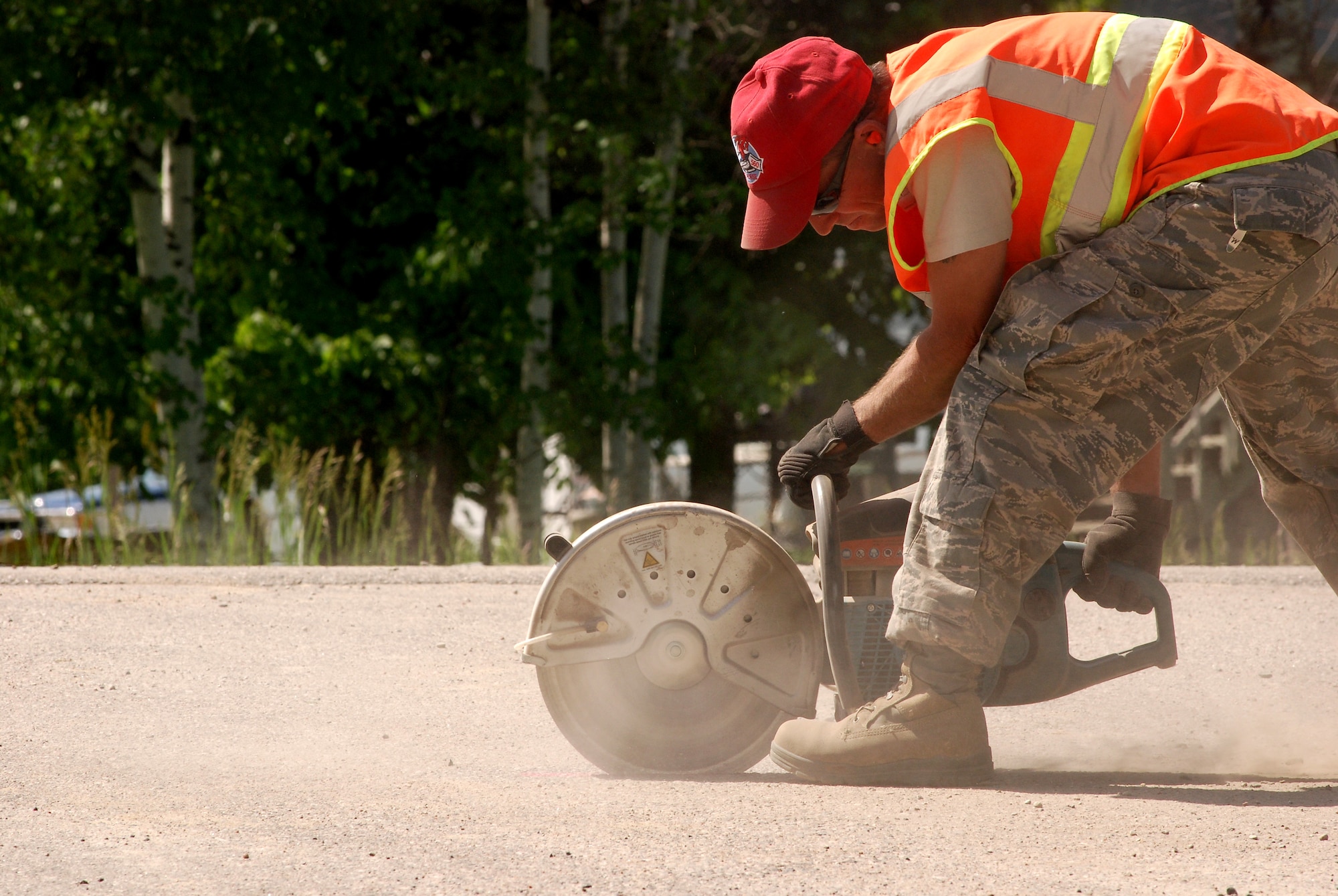 A member of the 560th RED HORSE Squadron from Charleston Air Force Base, South Carolina, cuts a section of ashphalt as part a humanitarian mission in the Red Lake Indian Reservation for the Red Lake band of Chippewa Indians, just outside of Bemidji, Minnesota. (U.S. Air Force photo/Airman 1st Class Brian McGloin)