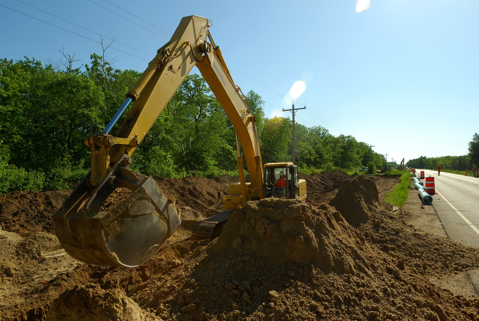 Members of the 433rd Civil Engineering Squadron conduct a humanitarian mission in the Red Lake Indian Reservation for the Red Lake band of Chippewa Indians, just outside of Bemidji, Minnesota. Staff Sgt. Garret Was, 446th CES Lewis-McChord Joint Base, Washington, operates an excavator to dig a ditch where a 12-inch water main will be installed. (U.S. Air Force photo/Airman 1st Class Brian McGloin)