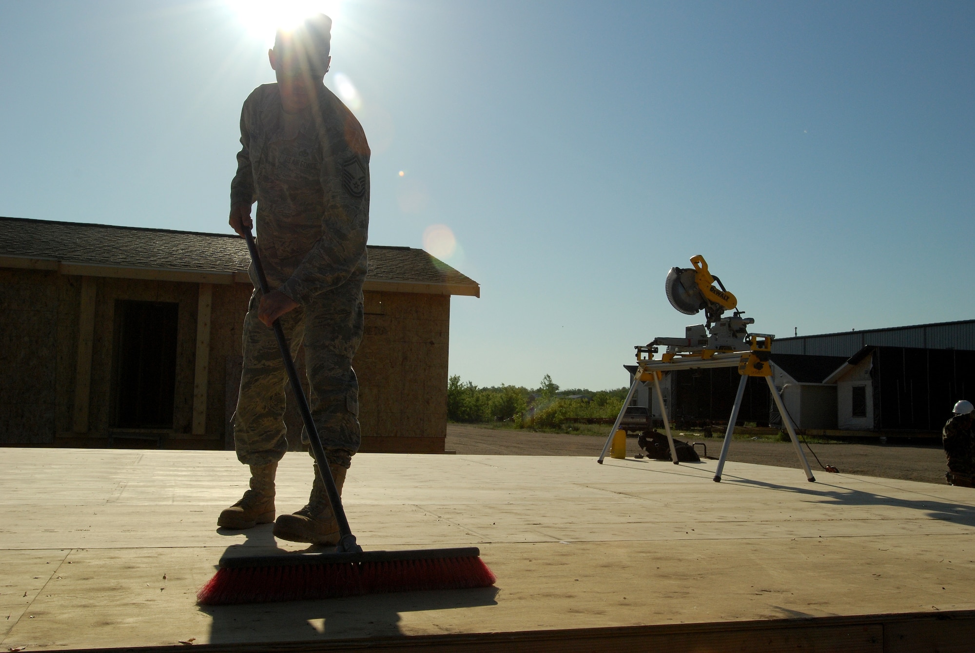Members of the 433rd Civil Engineering Squadron conduct a humanitarian mission in the Red Lake Indian Reservation for the Red Lake band of Chippewa Indians, just outside of Bemidji, Minnesota. Senior Master Sgt. Michael Barnes, 433rd CES, sweeps the subfloor before the framing forthe walls begins. (U.S. Air Force photo/Airman 1st Class Brian McGloin)