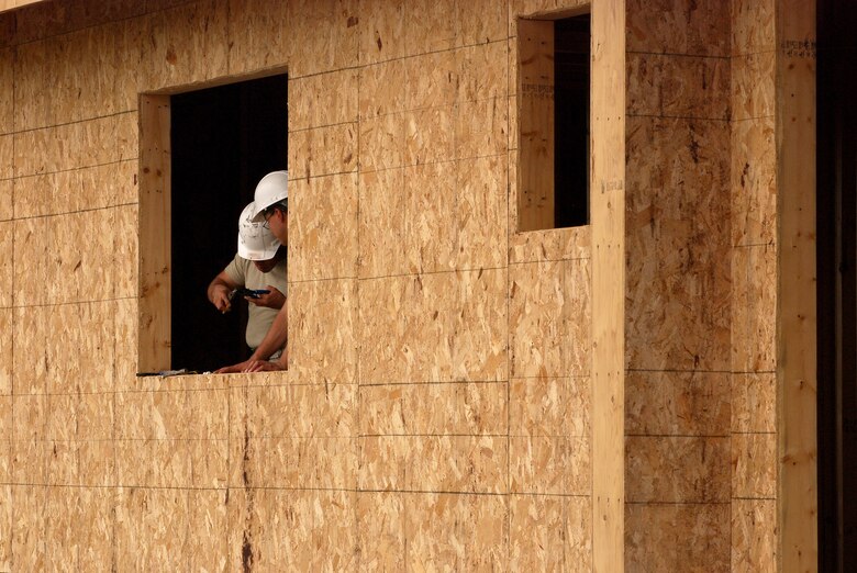 Members of the 433rd Civil Engineering Squadron conduct a humanitarian mission in the Red Lake Indian Reservation for the Red Lake band of Chippewa Indians, just outside of Bemidji, Minnesota. Staff Sgt. David Bustos and Senior Airman Jaime Payen, both 433rd CES electricians, at work wiring a house for electricity. (U.S. Air Force photo/Airman 1st Class Brian McGloin)