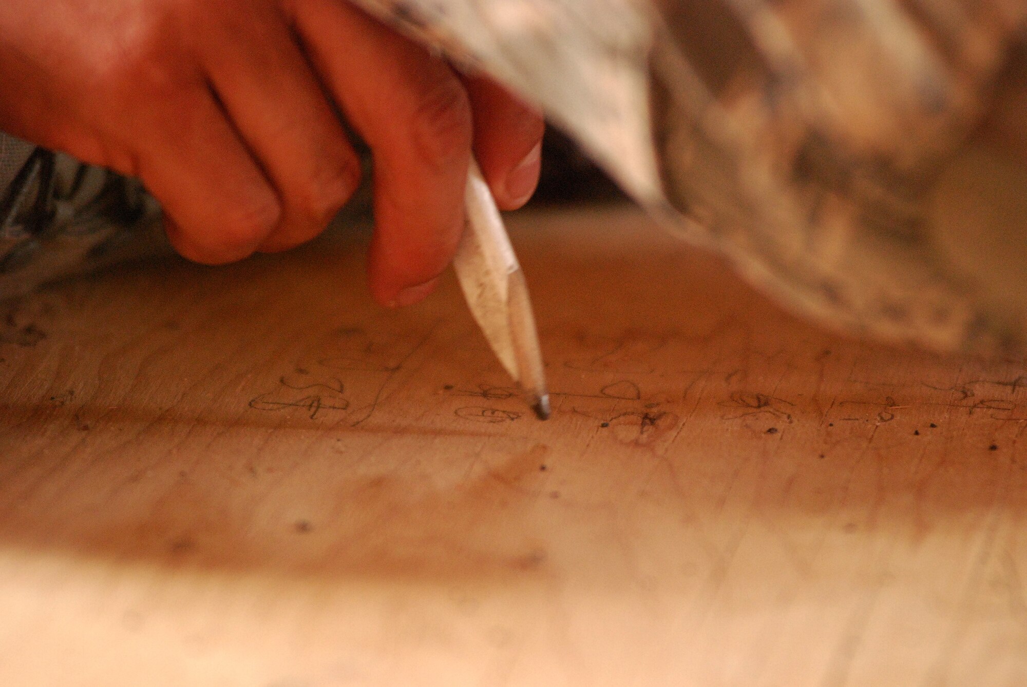 Members of the 433rd Civil Engineering Squadron conduct a humanitarian mission in the Red Lake Indian Reservation for the Red Lake band of Chippewa Indians, just outside of Bemidji, Minnesota. Senior Airman Jaime Payen, 433rd CES, makes some quick calcuations on the sub-floor of the house he is wiring.(U.S. Air Force photo/Airman 1st Class Brian McGloin)