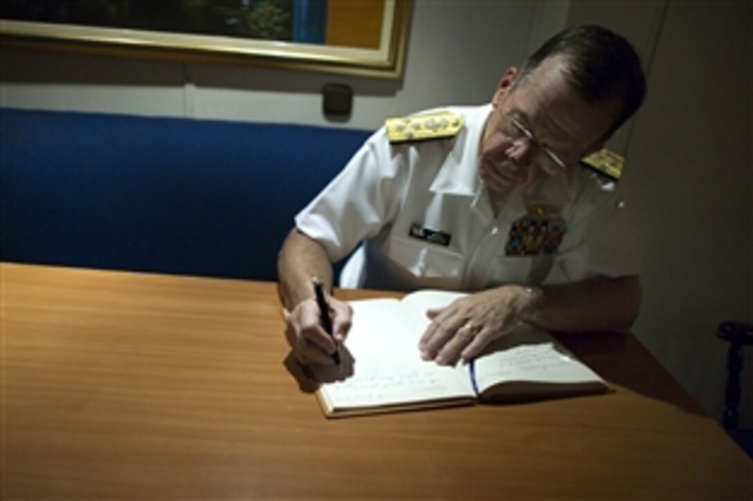 U.S. Navy Adm. Mike Mullen, chairman of the Joint Chiefs of Staff, signs the guest book after touring the Colombian frigate ARC Almirante Padilla in Cartegena, Colombia, June 30, 2010. Mullen visited the South American country to reaffirm the commitment between the two countries in their ongoing war against narco-terrorism.