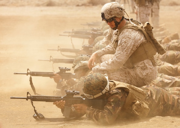 Cpl. Dave Spraker, a team leader with 3rd platoon, Company E, 2nd Battalion, 3rd Marine Regiment, instructs Royal Tongan Marines, Tonga Defence Services, during a battle sight zero exercise at the Marine Corps Base Hawaii Range Training Facility June 30. Service members from Australia, Canada, Indonesia, Malaysia and Tonga joined the 2/3 Marines in training as part of the Exercise Rim of the Pacific 2010, a biennial exercise designed to strengthen regional partnerships and improve bilateral interoperability.
