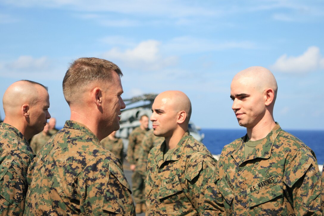 Cpl. Jarrett R. Rothrock, a small arms technician with the 31st Marine Expeditionary Unit (MEU), stands at the position of attention in front of Col. Paul L. Damren, 31st MEU Commanding Officer, preparing to pin his current rank during a promotion ceremony aboard the forward-deployed amphibious assault ship USS Essex (LHD 2), March 1. The MEU recently completed Exercise Cobra Gold 2010 (CG ’10) and is currently underway to the Republic of the Philippines in support of Exercise Balikatan 2010 (BK ’10).