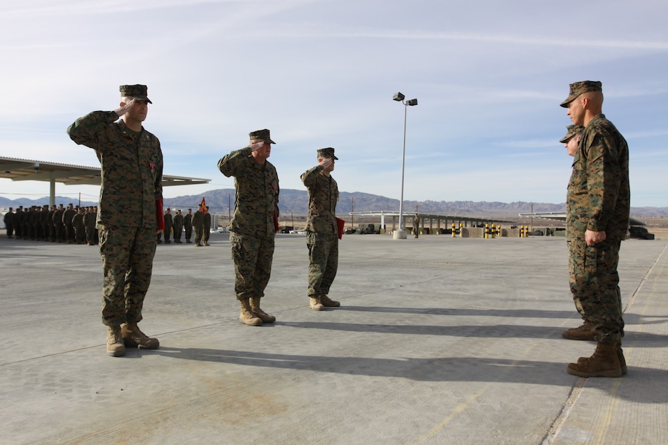Marines with 3rd Battalion, 11th Marine Regiment, salute Sgt. Maj. Maximino Torres III, the battalion’s sergeant major, and Lt. Col. Eduardo A. Abisellan, the commanding officer of the battalion, after receiving their awards during a morning colors ceremony at the battalion’s gun ramp March 2.
