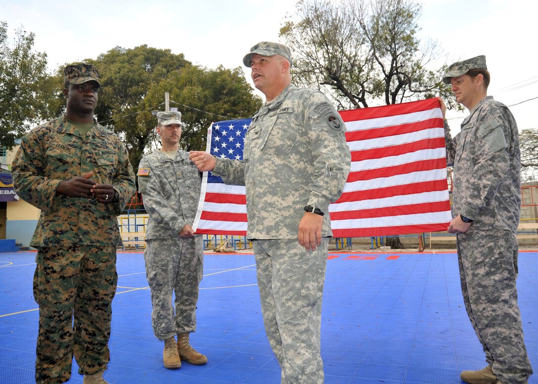 Staff Sgt. Michel Leandre Jr., a Haitian American U.S. Marine with Joint Forces Special Operations Component Command is about to be promoted to Gunnery Sgt. by Col. Daniel Stoltz, the commander Joint Forces Special Operations Component Command.  The United States and other international military and civilian aid agencies are conducting humanitarian and disaster relief operations as part of Operation Unified Response in the aftermath of the earthquake that hit the area on Jan. 12, 2010.