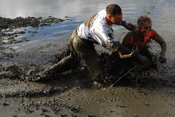 MARINE CORPS BASE HAWAII KANEOHE BAY, Hawaii -- More than 450 six-person teams got down and dirty during the muddiest race of the year at the Marine Corps' 16th Annual Swamp Romp Feb. 20. The Marine Corps Combat Service Support Group 3 and Marine Corps Community Services hosted the five-mile muddy obstacle course known as Oahu's "dirtiest footrace." Some teams dressed for the occasion by putting on their combat boots and strapping them down with duct tape, while others went for a more themed approach. Costumes from jail birds and ninjas to superheroes like Spiderman, Wonder Woman, Super Girl and a group of prom night beauty contestants were not in their best condition at the end of the race. (U.S. Air Force photo/ Staff Sgt. Mike Meares)