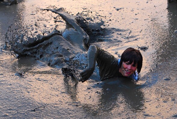 MARINE CORPS BASE HAWAII KANEOHE BAY, Hawaii -- More than 450 six-person teams got down and dirty during the muddiest race of the year at the Marine Corps' 16th Annual Swamp Romp Feb. 20. The Marine Corps Combat Service Support Group 3 and Marine Corps Community Services hosted the five-mile muddy obstacle course known as Oahu's "dirtiest footrace." Some teams dressed for the occasion by putting on their combat boots and strapping them down with duct tape, while others went for a more themed approach. Costumes from jail birds and ninjas to superheroes like Spiderman, Wonder Woman, Super Girl and a group of prom night beauty contestants were not in their best condition at the end of the race. (U.S. Air Force photo/ Staff Sgt. Mike Meares)