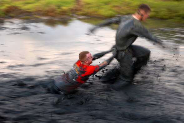 MARINE CORPS BASE HAWAII KANEOHE BAY, Hawaii -- More than 450 six-person teams got down and dirty during the muddiest race of the year at the Marine Corps' 16th Annual Swamp Romp Feb. 20. The Marine Corps Combat Service Support Group 3 and Marine Corps Community Services hosted the five-mile muddy obstacle course known as Oahu's "dirtiest footrace." Some teams dressed for the occasion by putting on their combat boots and strapping them down with duct tape, while others went for a more themed approach. Costumes from jail birds and ninjas to superheroes like Spiderman, Wonder Woman, Super Girl and a group of prom night beauty contestants were not in their best condition at the end of the race. (U.S. Air Force photo/ Staff Sgt. Mike Meares)