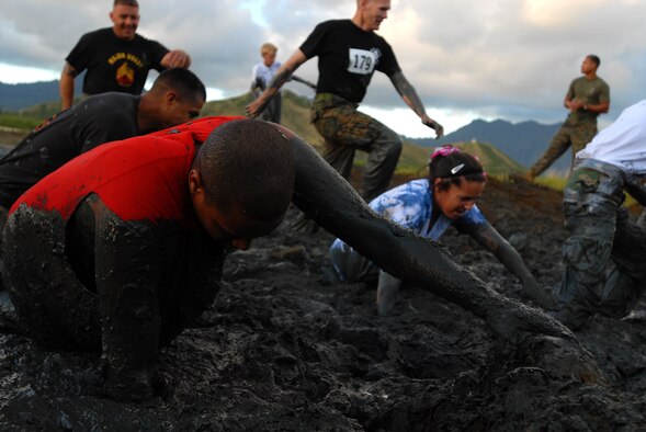MARINE CORPS BASE HAWAII KANEOHE BAY, Hawaii -- More than 450 six-person teams got down and dirty during the muddiest race of the year at the Marine Corps' 16th Annual Swamp Romp Feb. 20. The Marine Corps Combat Service Support Group 3 and Marine Corps Community Services hosted the five-mile muddy obstacle course known as Oahu's "dirtiest footrace." Some teams dressed for the occasion by putting on their combat boots and strapping them down with duct tape, while others went for a more themed approach. Costumes from jail birds and ninjas to superheroes like Spiderman, Wonder Woman, Super Girl and a group of prom night beauty contestants were not in their best condition at the end of the race. (U.S. Air Force photo/ Staff Sgt. Mike Meares)