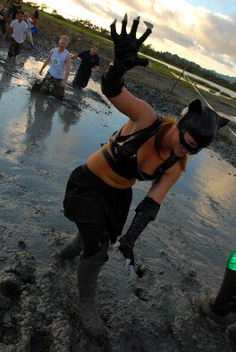 MARINE CORPS BASE HAWAII KANEOHE BAY, Hawaii -- More than 450 six-person teams got down and dirty during the muddiest race of the year at the Marine Corps' 16th Annual Swamp Romp Feb. 20. The Marine Corps Combat Service Support Group 3 and Marine Corps Community Services hosted the five-mile muddy obstacle course known as Oahu's "dirtiest footrace." Some teams dressed for the occasion by putting on their combat boots and strapping them down with duct tape, while others went for a more themed approach. Costumes from jail birds and ninjas to superheroes like Spiderman, Wonder Woman, Super Girl and a group of prom night beauty contestants were not in their best condition at the end of the race. (U.S. Air Force photo/ Staff Sgt. Mike Meares)