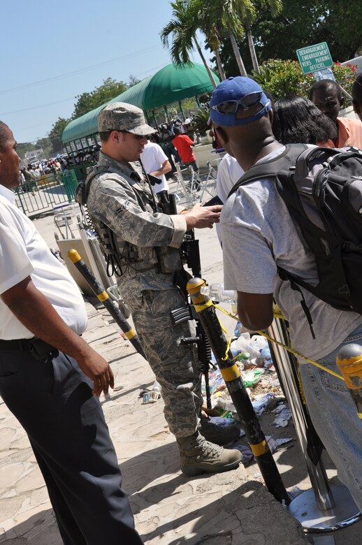 Airman 1st Class Adam Bearor helps provide security and process Haitian-Americans for repatriation to the U.S. at the Toussaint Louverture International Airport in Haiti. (U.S. Air Force photo/Capt. Dustin Doyle)