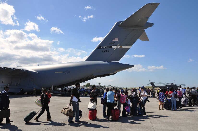 Evacuees board a C-17 Globemaster III from Travis Air Force Base in California. After dropping off Airmen, Soldiers, relief or logistical supplies, the Air Force used available space to take as many U.S. citizens back to the States as possible. More than 15,000 of U.S. citizens were repatriated during the operation. (U.S. Air Force photo/Capt. Dustin Doyle)
