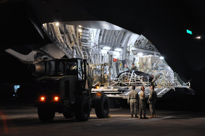 Upon arrival in Haiti, aerial porters from the 621st CRW immediately get to work unloading cargo and relief supplies from both military and civilian aircraft. The team downloaded more than 30 million pounds of relief supplies and equipment during the deployment. (U.S . Air Force photo/Capt. Dustin Doyle)
