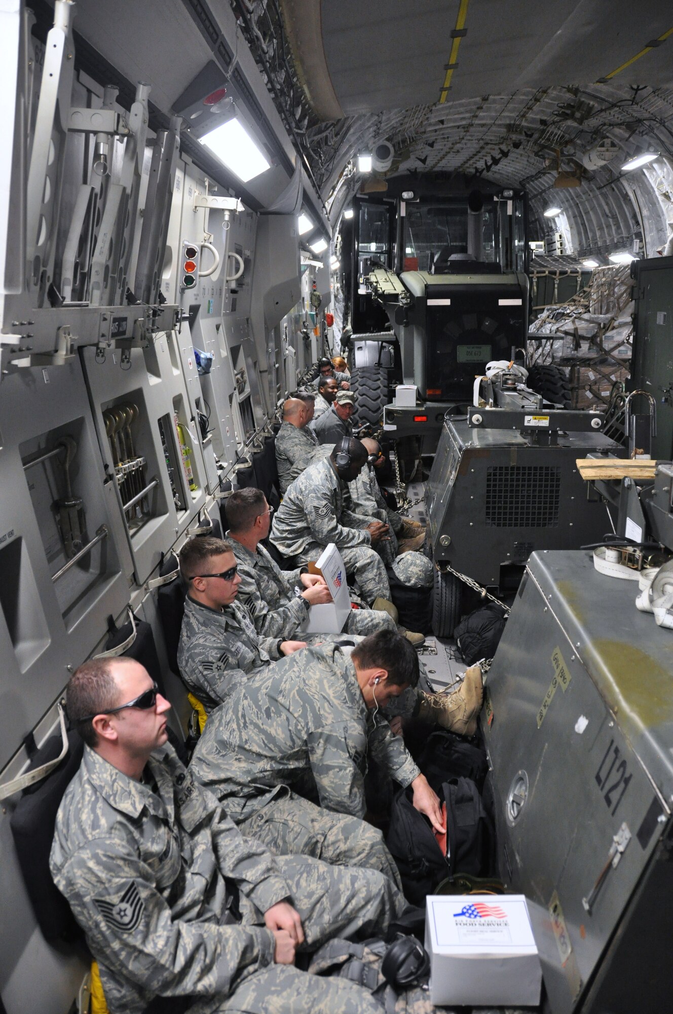 Airmen from the 621st Contingency Response Wing, based at Joint Base McGuire-Dix-Lakehurst, fly on-board a C-17 Globemaster III bound for Haiti. The team assisted the humanitarian relief effort by operating the Toussaint Louverture International Airport in Port au Prince, Haiti. (U.S. Air Force photo/Capt. Dustin Doyle)