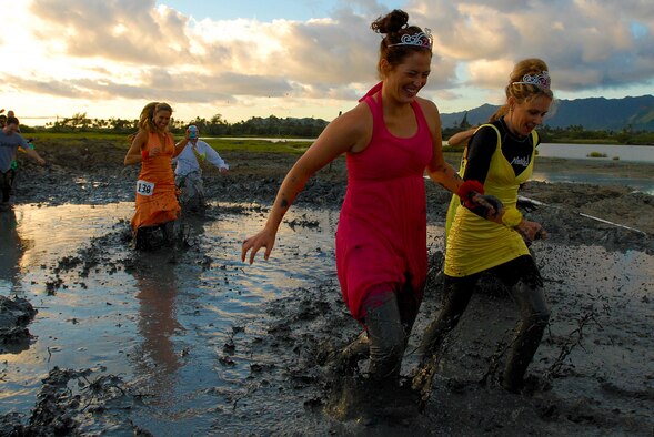 MARINE CORPS BASE HAWAII KANEOHE BAY, Hawaii -- More than 450 six-person teams got down and dirty during the muddiest race of the year at the Marine Corps' 16th Annual Swamp Romp Feb. 20. The Marine Corps Combat Service Support Group 3 and Marine Corps Community Services hosted the five-mile muddy obstacle course known as Oahu's "dirtiest footrace." Some teams dressed for the occasion by putting on their combat boots and strapping them down with duct tape, while others went for a more themed approach. Costumes from jail birds and ninjas to superheroes like Spiderman, Wonder Woman, Super Girl and a group of prom night beauty contestants were not in their best condition at the end of the race. (U.S. Air Force photo/ Staff Sgt. Mike Meares)