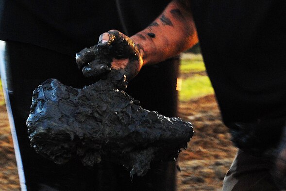MARINE CORPS BASE HAWAII KANEOHE BAY, Hawaii -- More than 450 six-person teams got down and dirty during the muddiest race of the year at the Marine Corps' 16th Annual Swamp Romp Feb. 20. The Marine Corps Combat Service Support Group 3 and Marine Corps Community Services hosted the five-mile muddy obstacle course known as Oahu's "dirtiest footrace." Some teams dressed for the occasion by putting on their combat boots and strapping them down with duct tape, while others went for a more themed approach. Costumes from jail birds and ninjas to superheroes like Spiderman, Wonder Woman, Super Girl and a group of prom night beauty contestants were not in their best condition at the end of the race. (U.S. Air Force photo/ Staff Sgt. Mike Meares)
