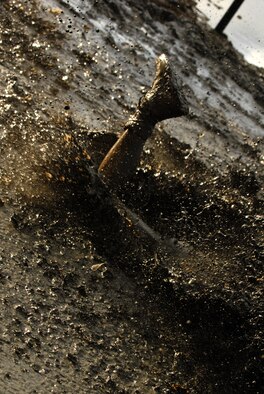 MARINE CORPS BASE HAWAII KANEOHE BAY, Hawaii -- More than 450 six-person teams got down and dirty during the muddiest race of the year at the Marine Corps' 16th Annual Swamp Romp Feb. 20. The Marine Corps Combat Service Support Group 3 and Marine Corps Community Services hosted the five-mile muddy obstacle course known as Oahu's "dirtiest footrace." Some teams dressed for the occasion by putting on their combat boots and strapping them down with duct tape, while others went for a more themed approach. Costumes from jail birds and ninjas to superheroes like Spiderman, Wonder Woman, Super Girl and a group of prom night beauty contestants were not in their best condition at the end of the race. (U.S. Air Force photo/ Staff Sgt. Mike Meares)