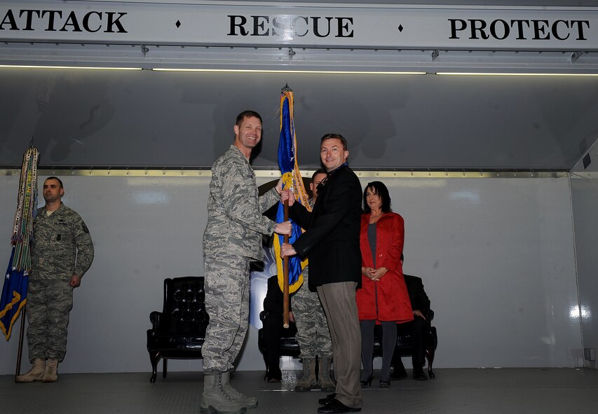 MOODY AIR FORCE BASE, Ga. -- (Left) Col. Gary Henderson, 23rd Wing commander, exchanges the guidon with a Valdosta community leader during Moody’s Honorary Commander change of command ceremony here Feb. 25.The program allows military members to educate those with limited knowledge about the Air Force and the installation. (U.S. Air Force photo by Airman 1st Class Joshua Green)
