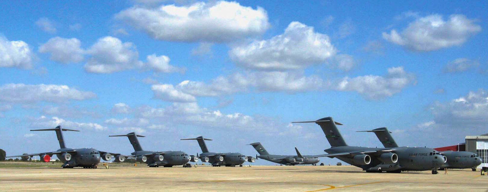 NAVAL STATION ROTA, Spain- Six C-17 Globemaster III aircraft line the flightline against a backdrop of sunny skies here. A 16-member maintainer team with the Air Force Reserve's 446th Aircraft Maintance Squadron, Joint Base Lewis-McChord, Wash., returned Feb. 6 from here after a two-week assignment, where they assisted the 725th Air Mobility Squadron in handling almost 30 C-17 Globemaster III aircraft that made stopovers there since Jan. 23. (Courtesy photo/U.S. Navy)