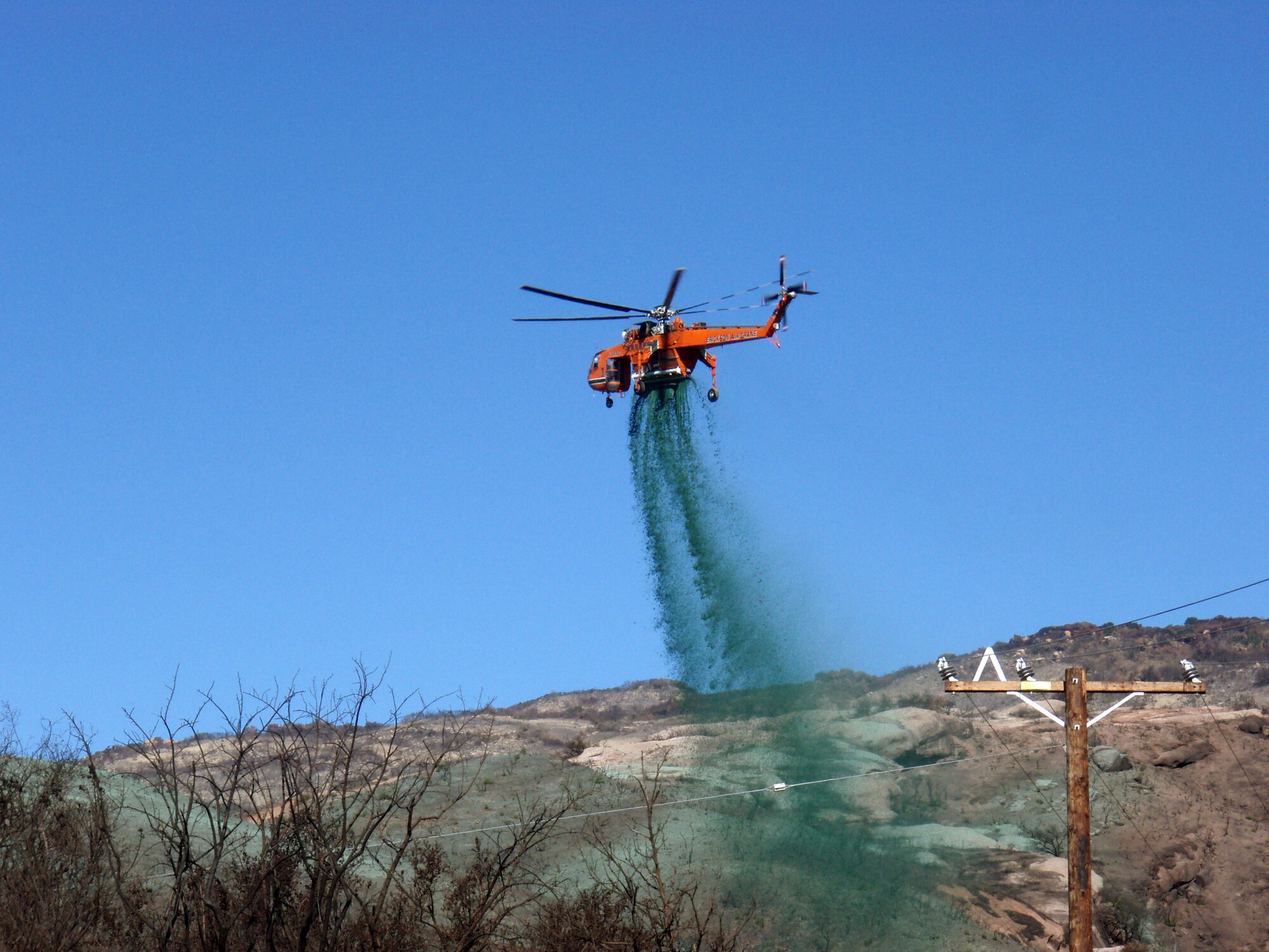 Hydromulch, used for reseeding and erosion control and manufactured by Fiberwood LLC at the former McClellan Air Force Base in Sacramento, Calif., is sprayed after a grass fire near Santa Barbara, Calif.  The mulch, made of recycled newspaper, can be applied as soon as a fire is out. (Courtesy photo)