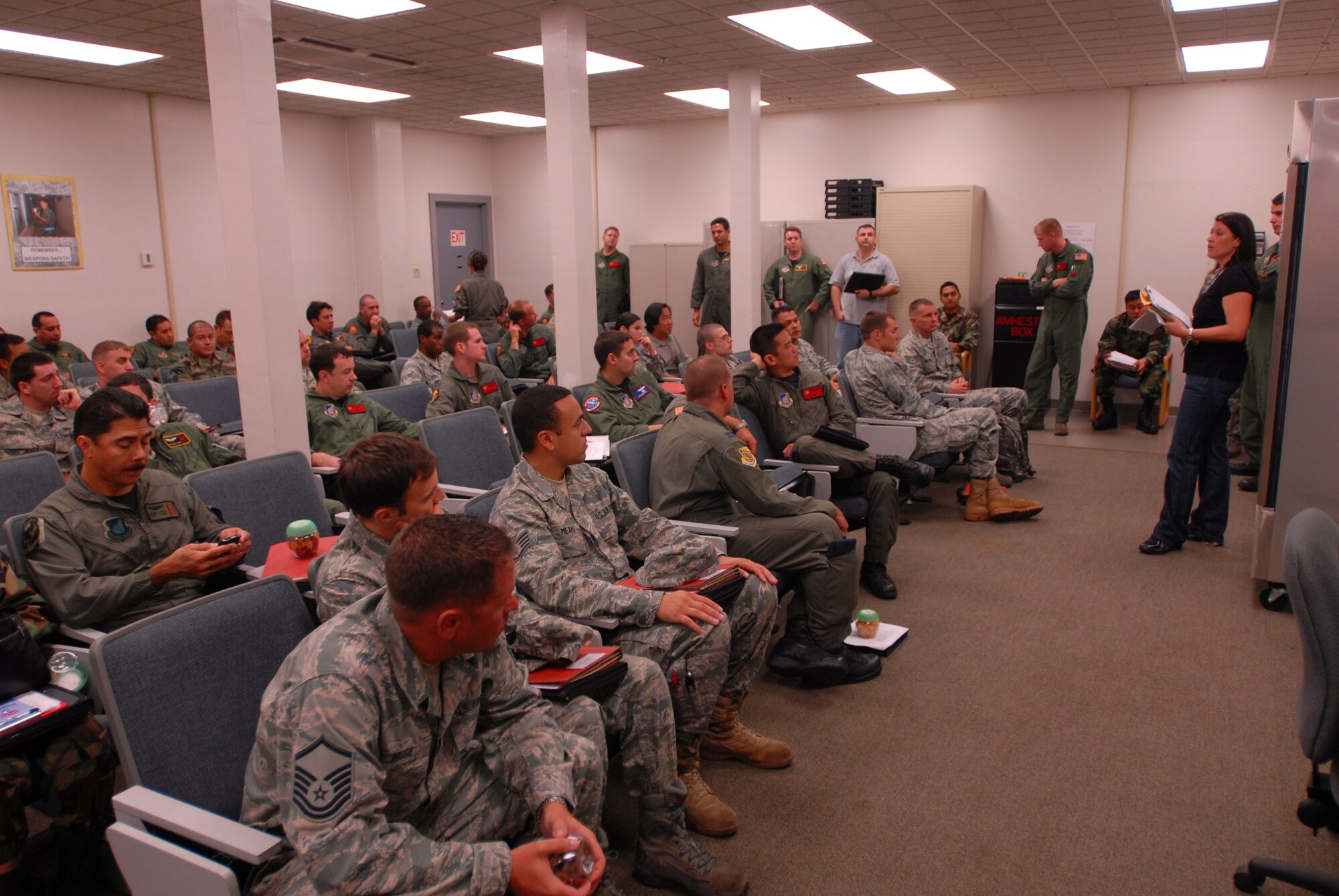 JOINT BASE PEARL HARBOR HICKAM, Hawaii - Michelle Branco,15th Mission Support Squadron personel deployment function chief, briefs airmen a day prior to taking off to Thailand for exercise Cope Tiger here, Feb. 25.Cope Tiger is an annual exercise conducted in Asia-Pacific and includes humanitarioan and civic assistance program. Aviation and ground units from the U.S. Air Force, Republic of Singapore Air Force, and Royal Thai Air Force and Army will participate in the exercise from 1 Mar. through 12 Mar. (U.S. Air Force photo/Senior Airman Gustavo Gonzalez)
