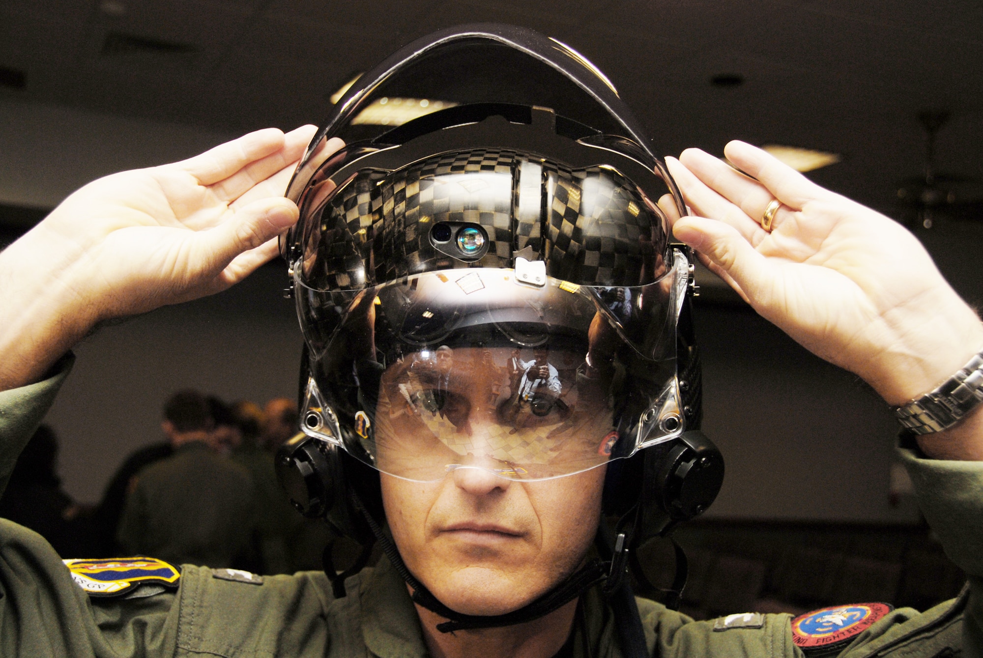 Navy Capt. Mike Saunders tries on the new F-35 Lightning II joint strike fighter helmet after getting measured for the new flight suit Feb. 25, 2010, at Eglin Air Force Base, Fla. Captain Saunders is the 33rd Operations Group deputy commander. (U.S. Air Force photo/Airman 1st Class Anthony Jennings)
