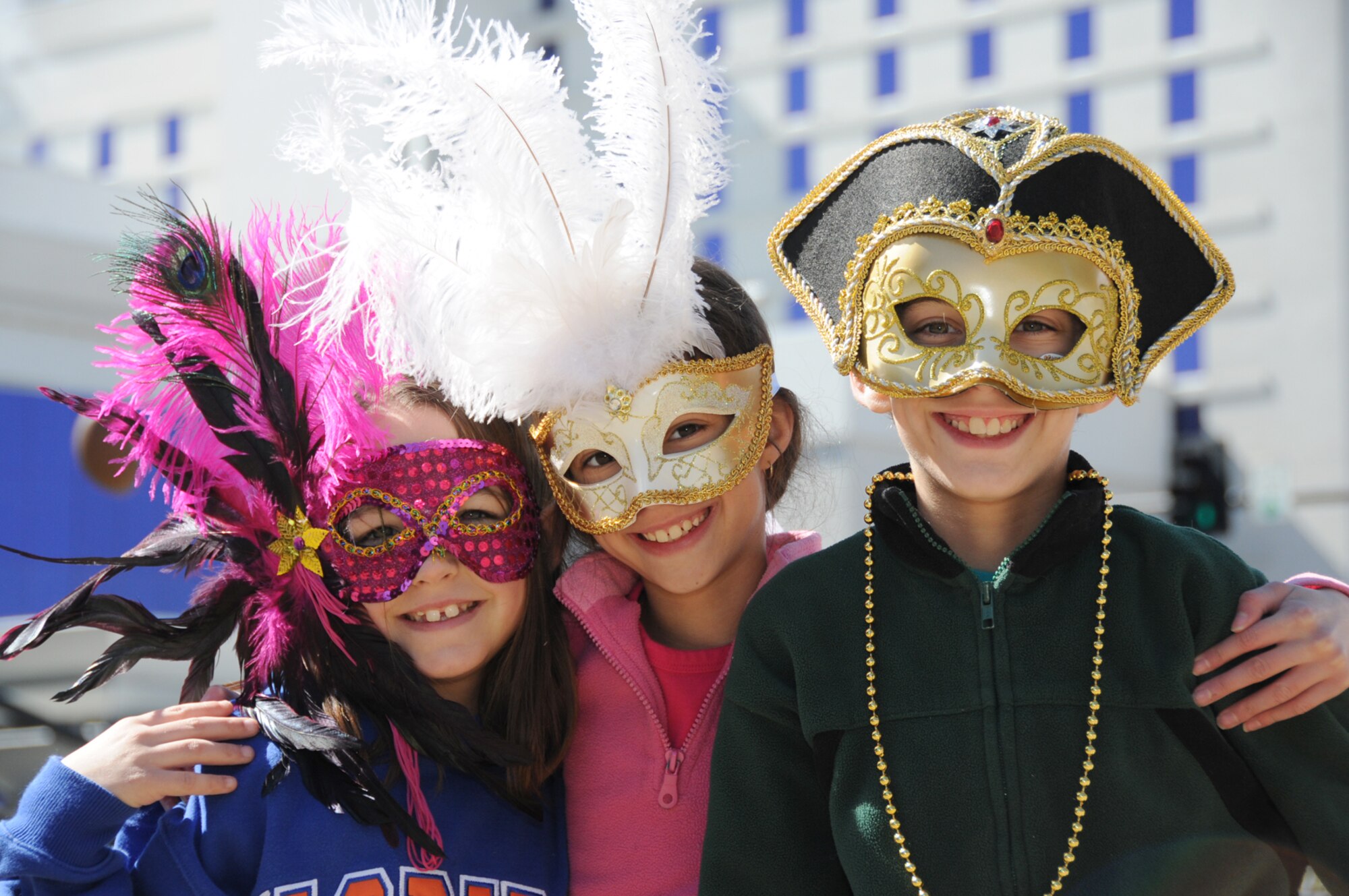 From left, Madison Hogsten, 8;  Kassie Diroma, 9, and her brother Alec, 10, enjoy Mardi Gras festivities on Feb. 16 in Biloxi.  The airman and family readiness center hosted a cookout for the family members of Keesler's deployed Airmen at the Biloxi Town Green which is along the route for the Gulf Coast Carnival Association Mardi Gras parade.  Madison is the daughter of Tech. Sgt. Marcus and Rachel Hogsten, 81st TRSS.  Sergeant Hogsten is currently on a one-year deployment to South West Asia.  Kassie and Alec's parents are Tech. Sgt. Phillip and Diane, 81st MDTS.(U.S. Air Force photo by Kemberly Groue)


