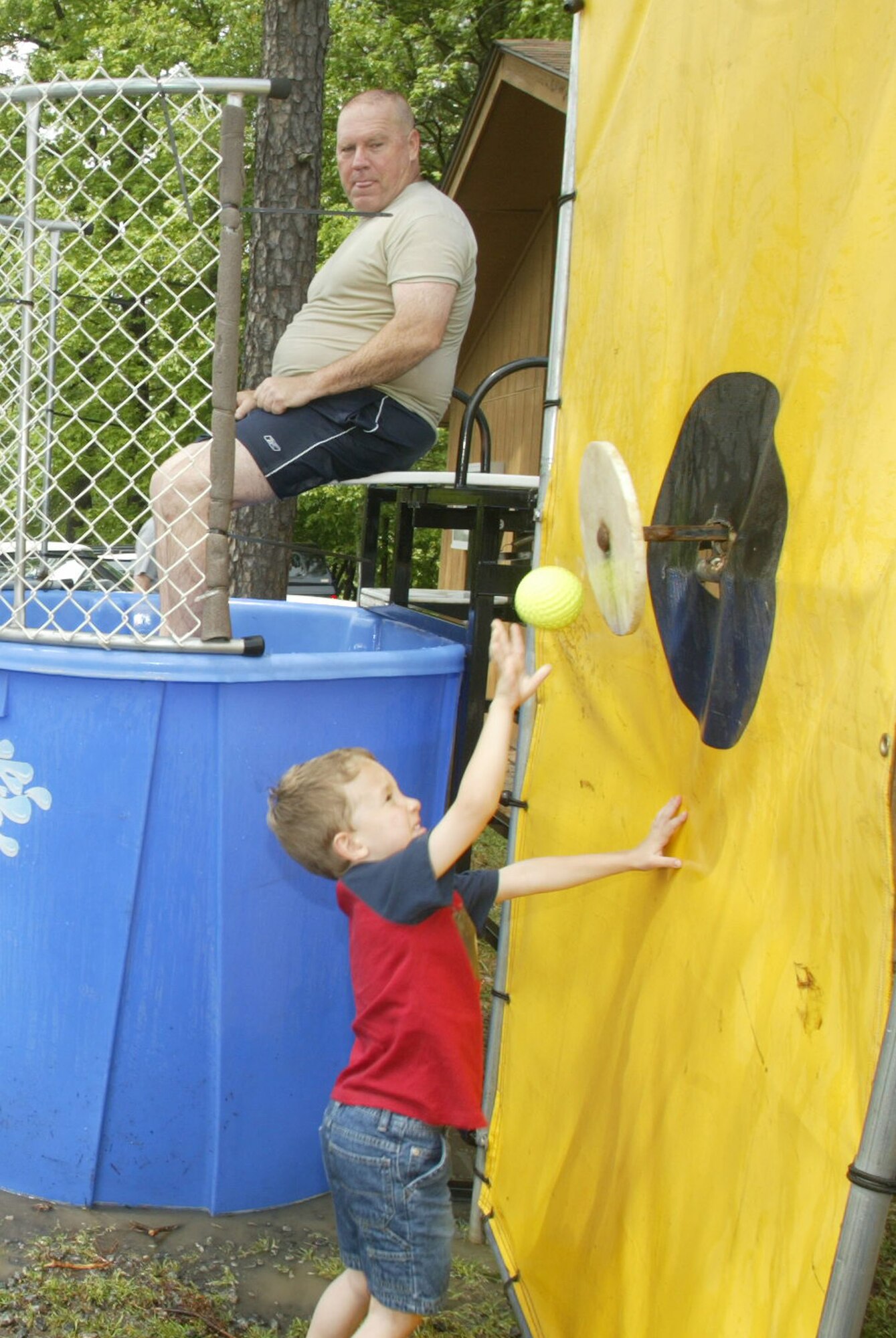 A young boy has the advantage trying to soak Chief Master Sgt. John Anderson, 94th Airlift Wing Command Chief, during Family Day 2009. Family Day 2010 is scheduled for May 1 from 11 a.m. to 4 p.m. at the Lakeside Pavilion.