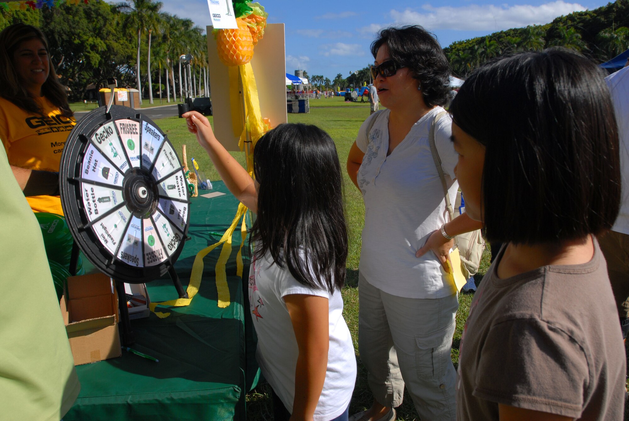 JOINT BASE PEARL HARBOR HICKAM, Hawaii - Jessica Ma, 9, spins the Geico spinning wheel for a chance to earn a prize during Mahalo Fest here, Feb. 26. Mahalo Fest was hosted by the 15th Services Squadron marketing team in support of customer appreciation week. (U.S. Air Force photo/Senior Airman Gustavo Gonzalez)