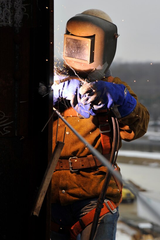 A welder from Miscellaneous Metals Inc. wields I-Beams together at the new William A. Jones III headquarters building Feb. 23, 2010 at Joint Base Andrews, Md.  These beams will be the main support beams for the entire building. The $114.2 million building is scheduled to be completed next year. (U.S. Air Force photo by Airman 1st Class Perry Aston) (Released)